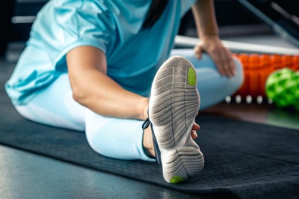 woman-stretching-legs-exercise-mat-before-training-gym_169016-47259.jpg Recovery and Mobility Drills